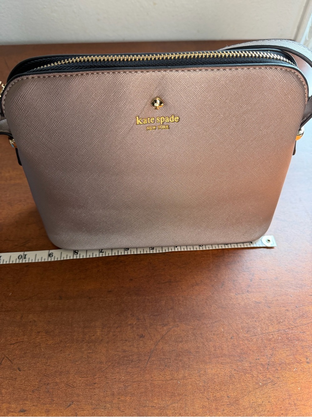 kate spade metallic taupe purse with gold logo